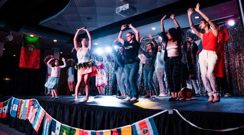 Students dancing on stage during hispanic heritage month.