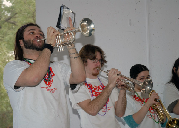 Three students playing trumpets