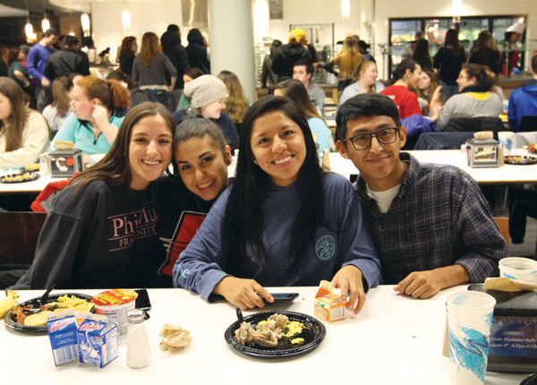 Four students eating breakfast meal