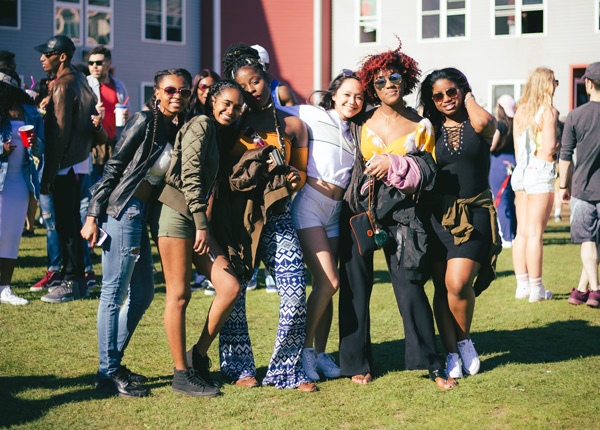 Six students posing in front of dorm housing