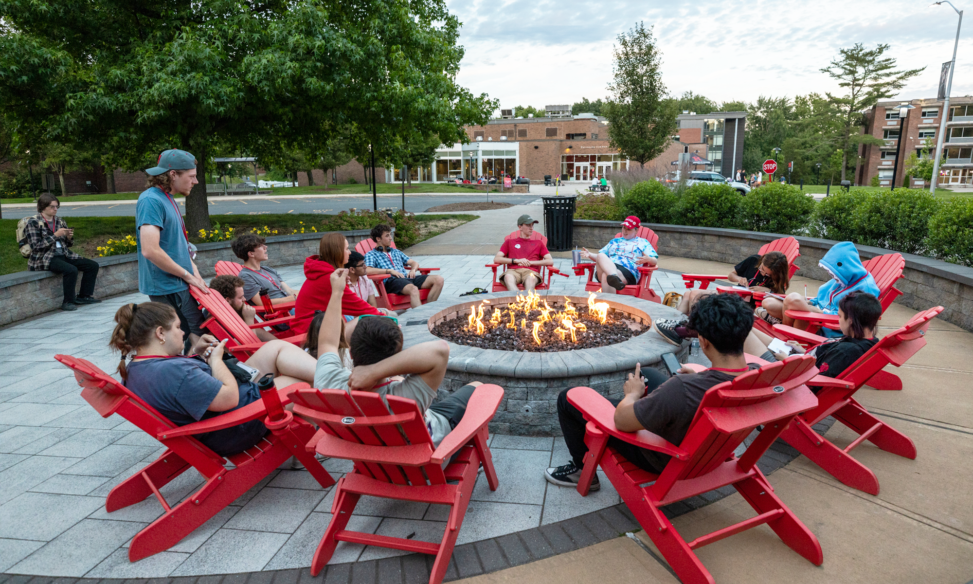 students sitting at firepit
