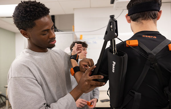 UHart student engaging in hands on learning in a classroom