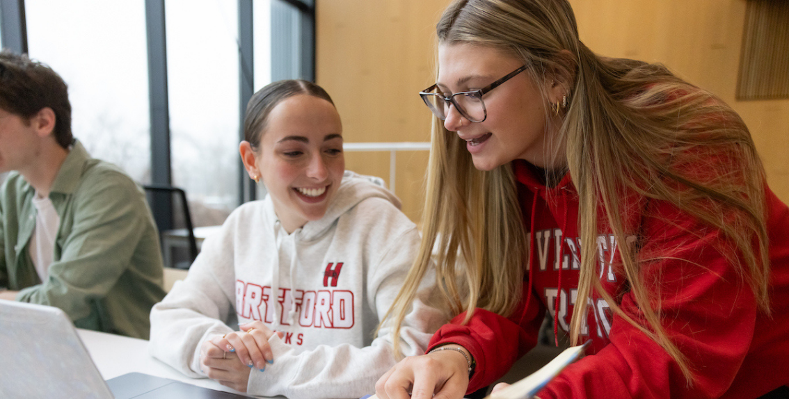 Uhart students in classroom talking 