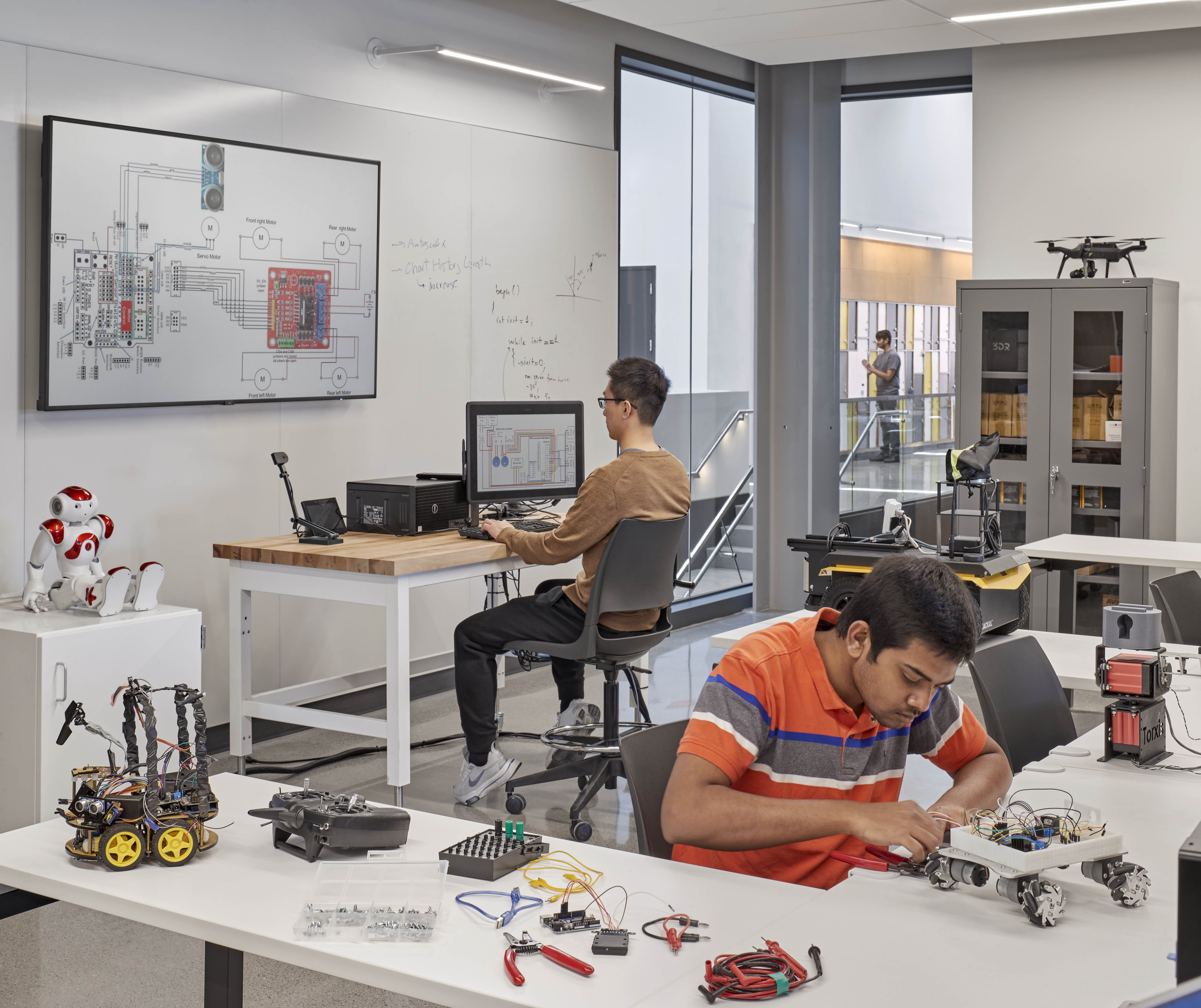 professor and students working on robots