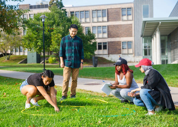 Students working on project outside on quad