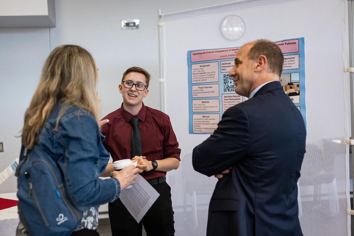 Student presenting poster board 