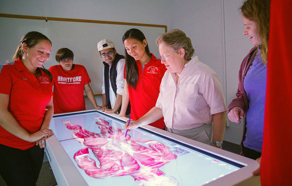 Students studying anatomage.
