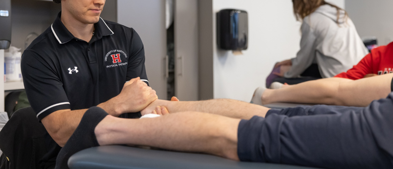 students practicing physical therapy in lab