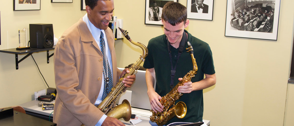 Javon Jackson works with a saxophone student