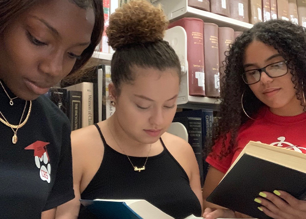 A group of Summer bridge students reading the Harrison Library in between classes.