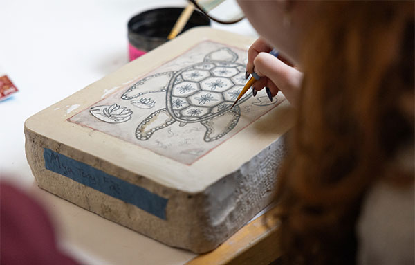 Student working on a printmaking project