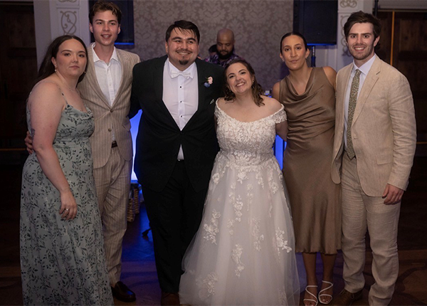 Ashleigh and Marcelino posing with wedding guests