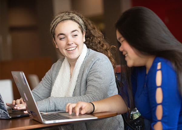 Student interns working together in GSU Hawk Lounge