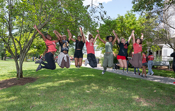 Students from the LEAD Program jumping in the air