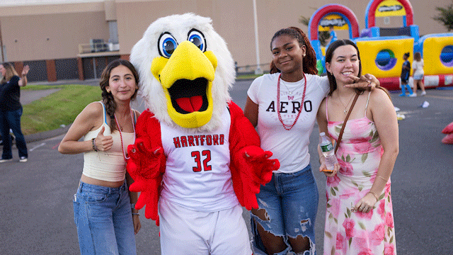 students posing with Howie at Hawktober