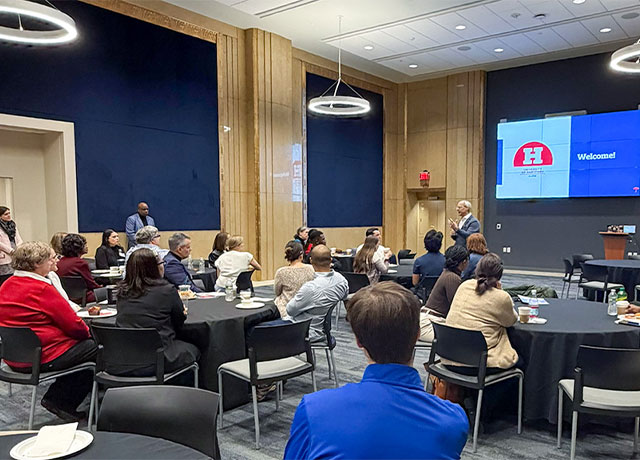 Alumni attend a breakfast for Travelers and UHart partnership