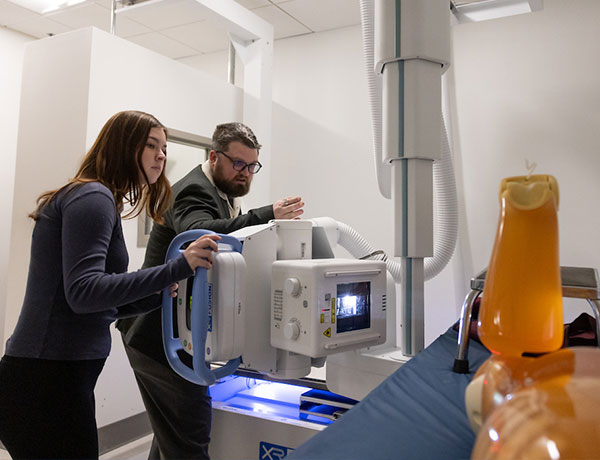 Student and Professor using equipment in UHart's new Rad Tech Lab