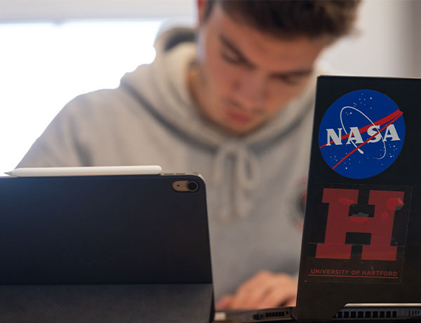 UHart and NASA logos on a student's computer