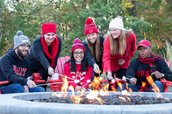 students making s'mores around the Poe fire pit