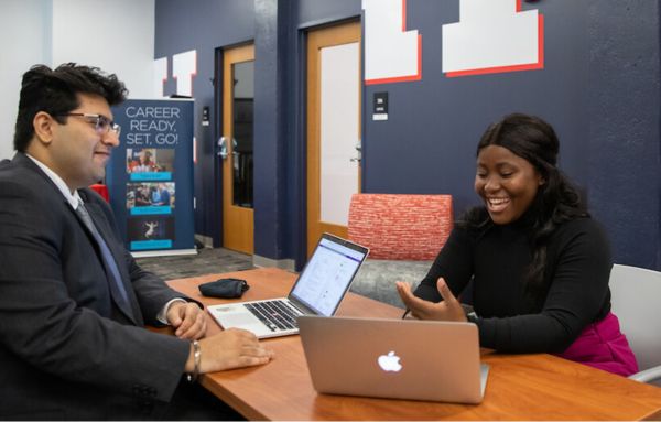 A first-year student sits with a UHart Career Partner and practices her interviewing skills.