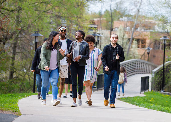 students walking over bridge