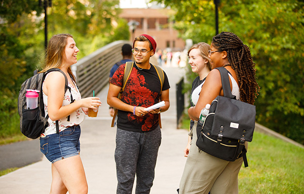 students talking in alumni plaza