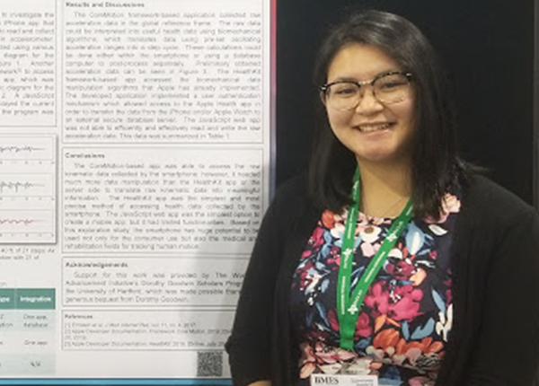 female student infront of poster