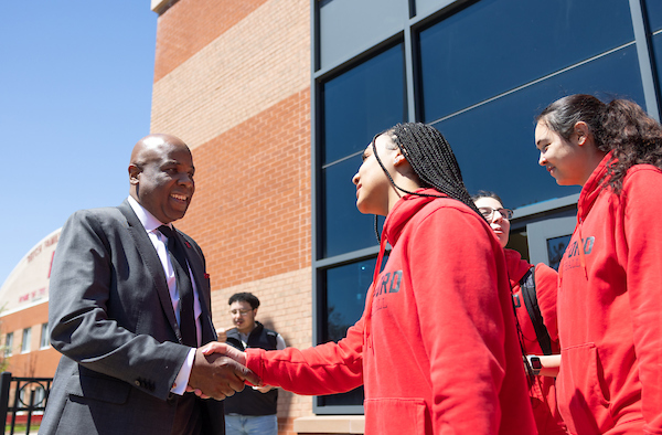 President Lawrence P. Ward receives an athletic jersey